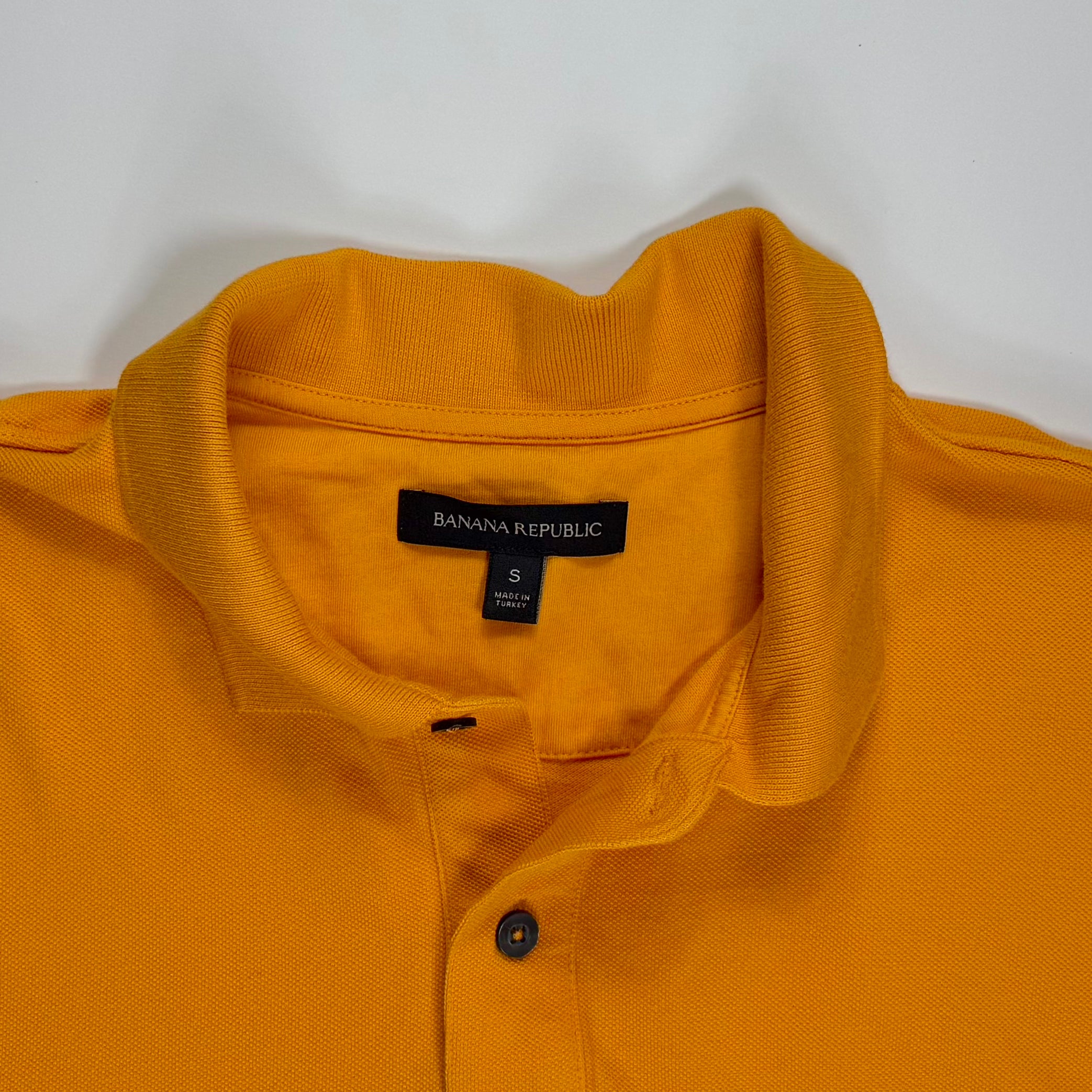 POLO MOSTAZA CON FRANJA NEGRA PARA HOMBRE | BANANA REPUBLIC | TALLA S