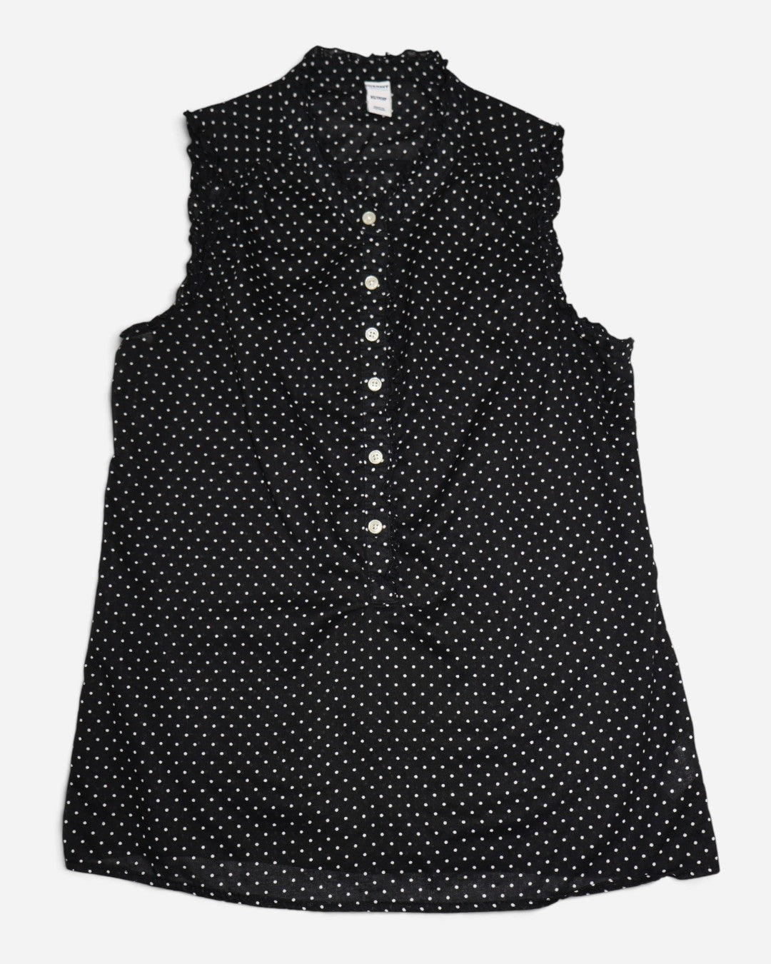 Blusa negra sin mangas con lunares blancos, botones y detalles de vuelos.